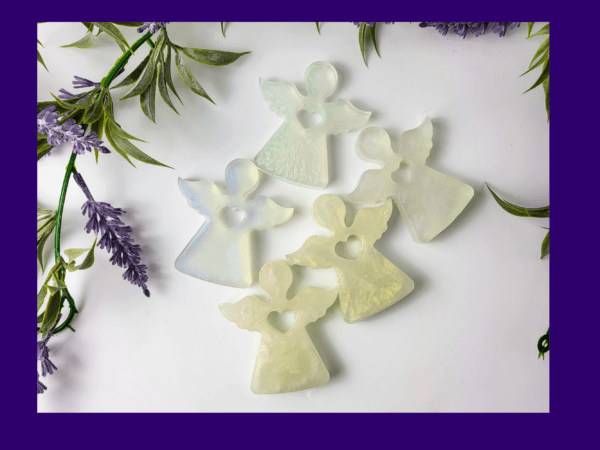 Five resin angels displayed on a white background, each delicately crafted and individually coloured