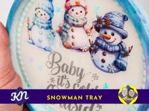 Close-up of snowman tray showing three winter snowmen and decorative blue border with Kirnix Creations branding.