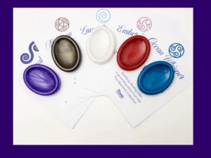 Five handcrafted resin calming stones displayed on their corresponding element meaning cards
