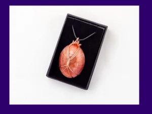Copper-wire wrapped oval resin pendant in warm autumn tones presented in a black gift box – artisan handmade necklace by Kirnix Creations