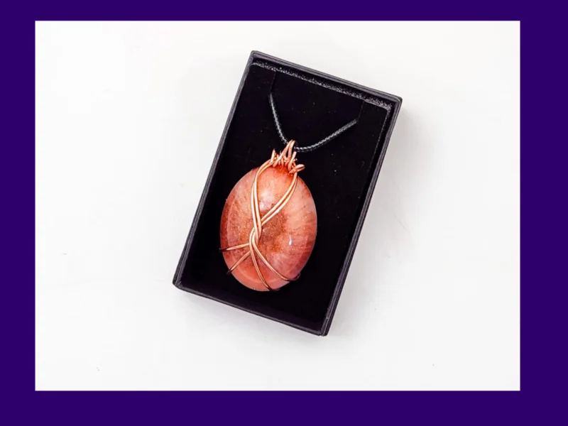 Copper-wire wrapped oval resin pendant in warm autumn tones presented in a black gift box – artisan handmade necklace by Kirnix Creations