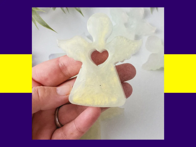 Hand holding a resin Guardian Angel in the gold pearlescent colour variant.