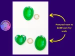 Pocket Peepers size comparison photo showing the green Heart and Oval shapes next to a £1 coin for scale.