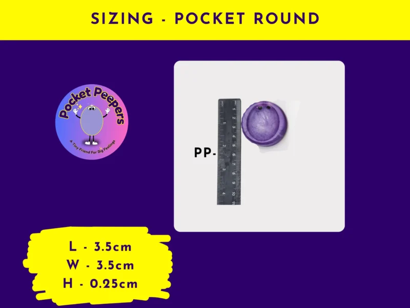 Pocket Peepers round-shaped fidget pebble placed next to a ruler to demonstrate its dimensions clearly