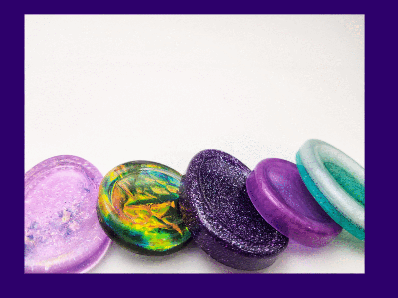 Assorted one-of-a-kind resin calming stones in mixed colours, shown as examples for the Chaos Solo lucky dip