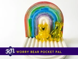 Yellow handheld and keyring Worry Bear pocket pals on rainbow arch tray with Kirnix Creations banne