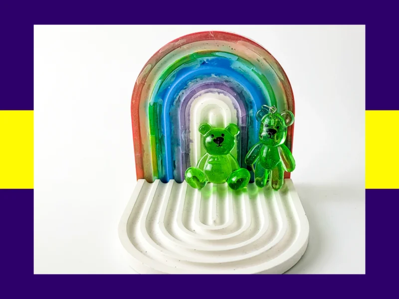 Green resin Worry Bear handheld and keyring pair displayed on white rainbow arch tray – fidget friendly calming bear set