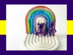 Purple resin Worry Bear handheld and keyring pair displayed on white rainbow arch tray – pocket calming bears