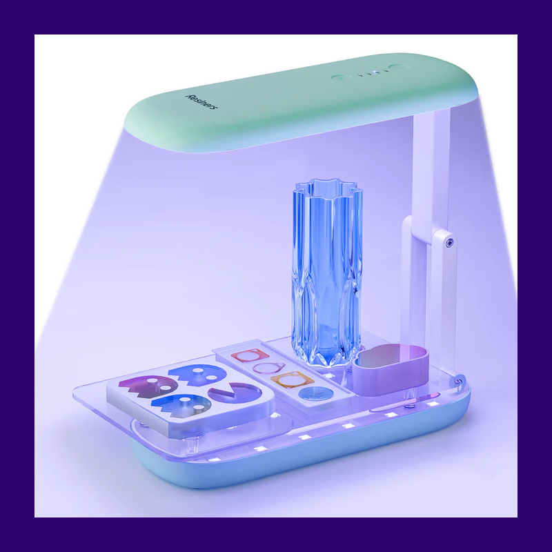Resiners UV curing station with illuminated tray and adjustable lamp arm, resin pieces on the base.