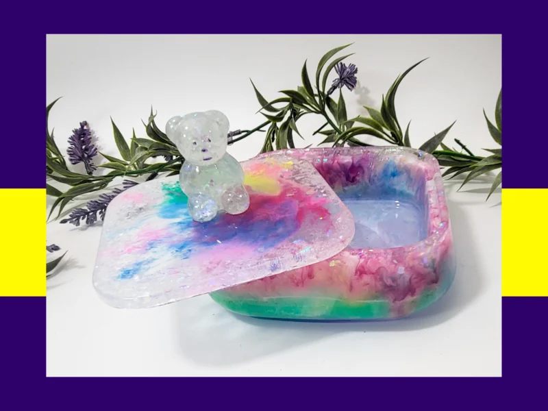 Open candycore resin treasure box showing the inside, with the lid tilted and the glitter teddy visible on top.