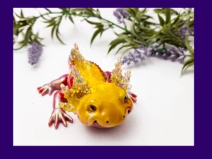 Front view of yellow-and-red Sparkle Axolotl resin figurine
