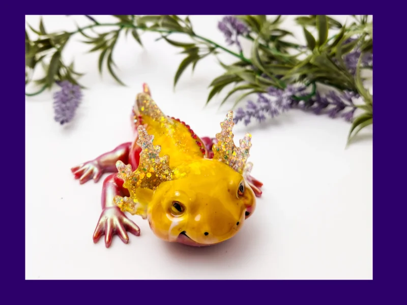 Front view of yellow-and-red Sparkle Axolotl resin figurine