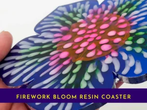 “Close-up view of the firework bloom resin coaster showing layered pink, green and white petal details.”
