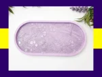 “Front view of pastel resin trinket tray featuring raised dragonflies, butterflies and floral details.”