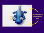 Ice axolotl photographed beside a £1 coin for scale with explanatory text.