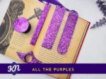 “All the Purples” hero image showing the full purple glitter set on an open book with banner text.