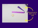 Purple glitter bookmark and tassel beside a coin for scale, with arrows showing the coin reference.
