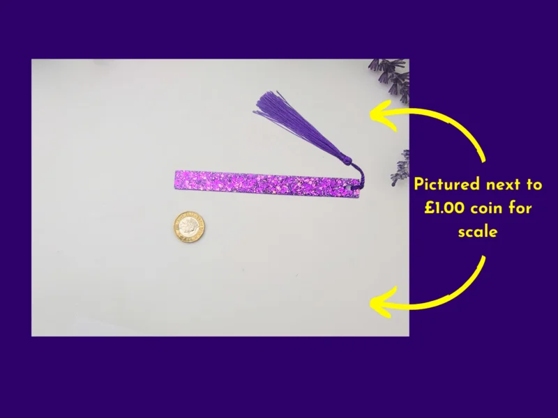 Purple glitter bookmark and tassel beside a coin for scale, with arrows showing the coin reference.
