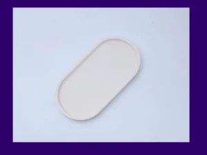 Angled product photo of the medium oval Aquacast eco resin tray in soft white on a plain background.