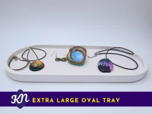 White oval tray holding several necklaces and small jewellery items, with a purple banner reading “Extra Large Oval Tray