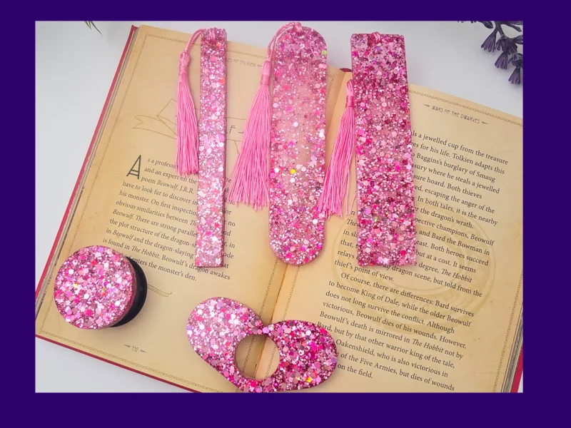 Pink glitter bookmark set laid out on an open book (all five styles visible).