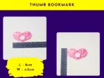 Thumb bookmark size graphic showing heart-shaped pink glitter thumb bookmark next to rulers (labelled “Thumb Bookmark”).